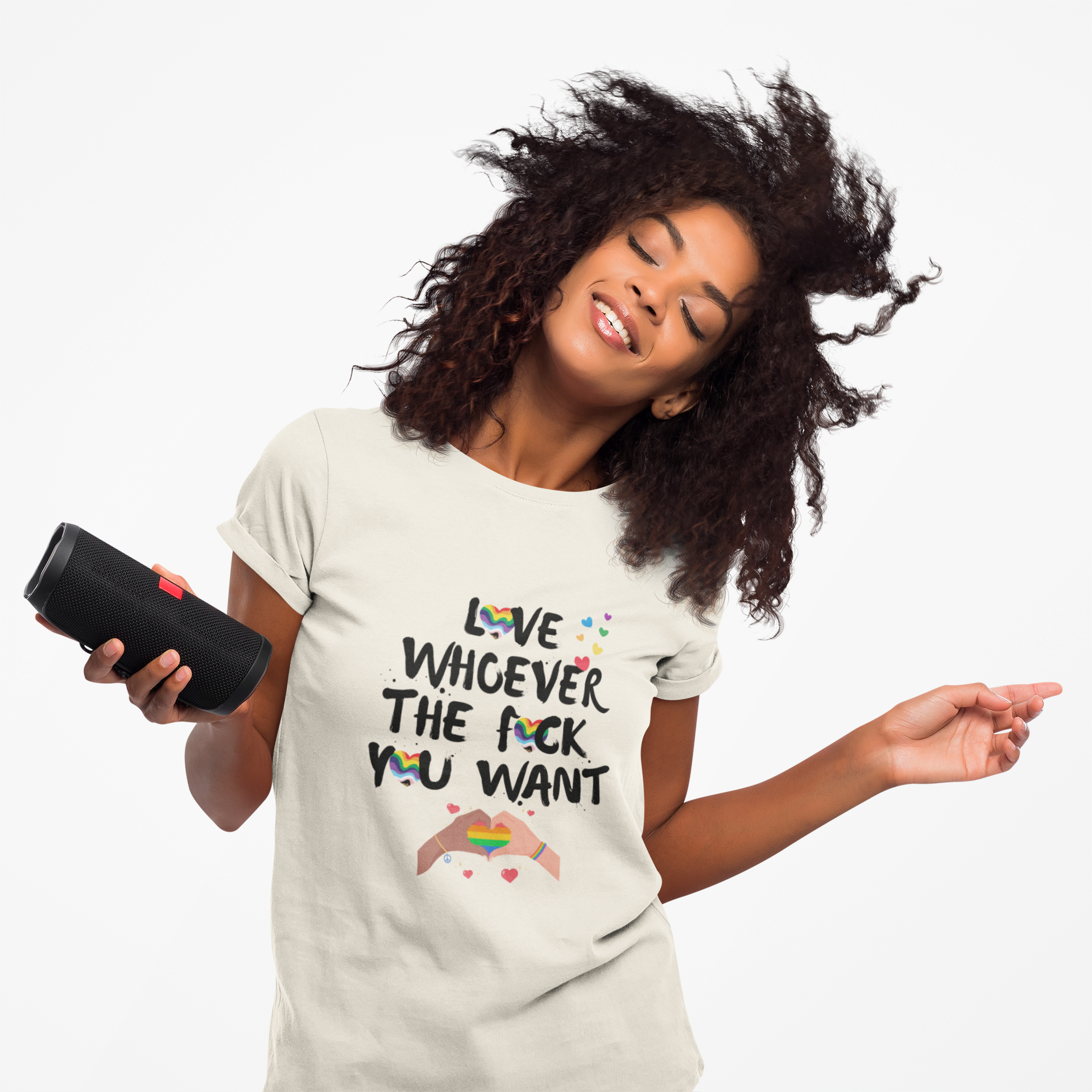 Woman wearing a t-shirt with a colorful message, holding a black object.