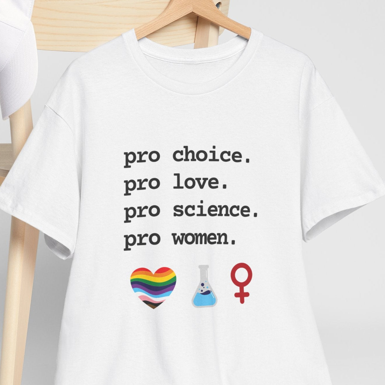 White t-shirt with pro-choice message and symbols on a wooden chair against a white background